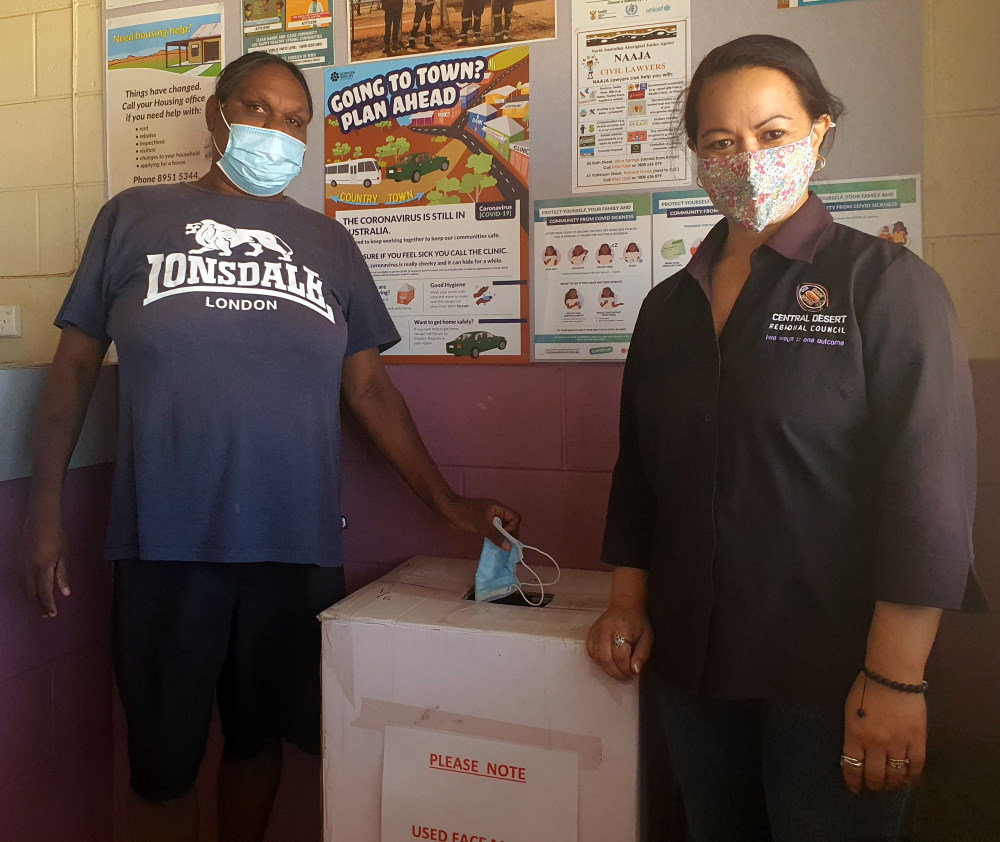 Natalie Petrick – Community Safety Patrol, and Di Schrader – Atitjere Administration Officer, using the face mask disposal box