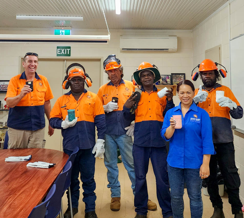 The Atitjere Works crew taking precautions for morning tea, with the office crew.