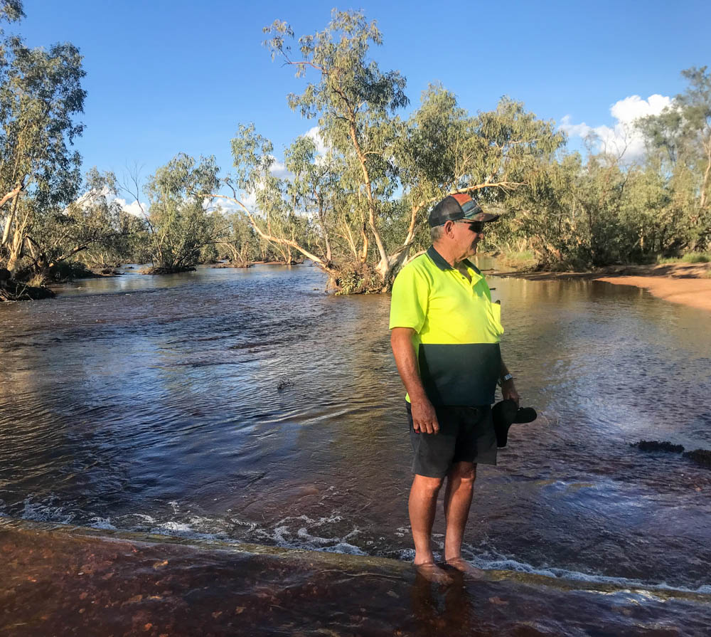 Rodney Baird checking the water level at Hanson Creek earlier in the month.
