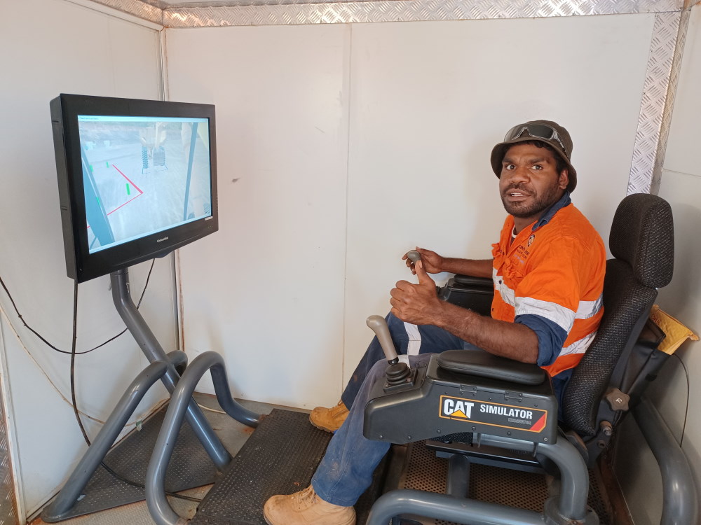 Kasman Spencer from Yuendumu Council Services enjoying the excavator simulator.